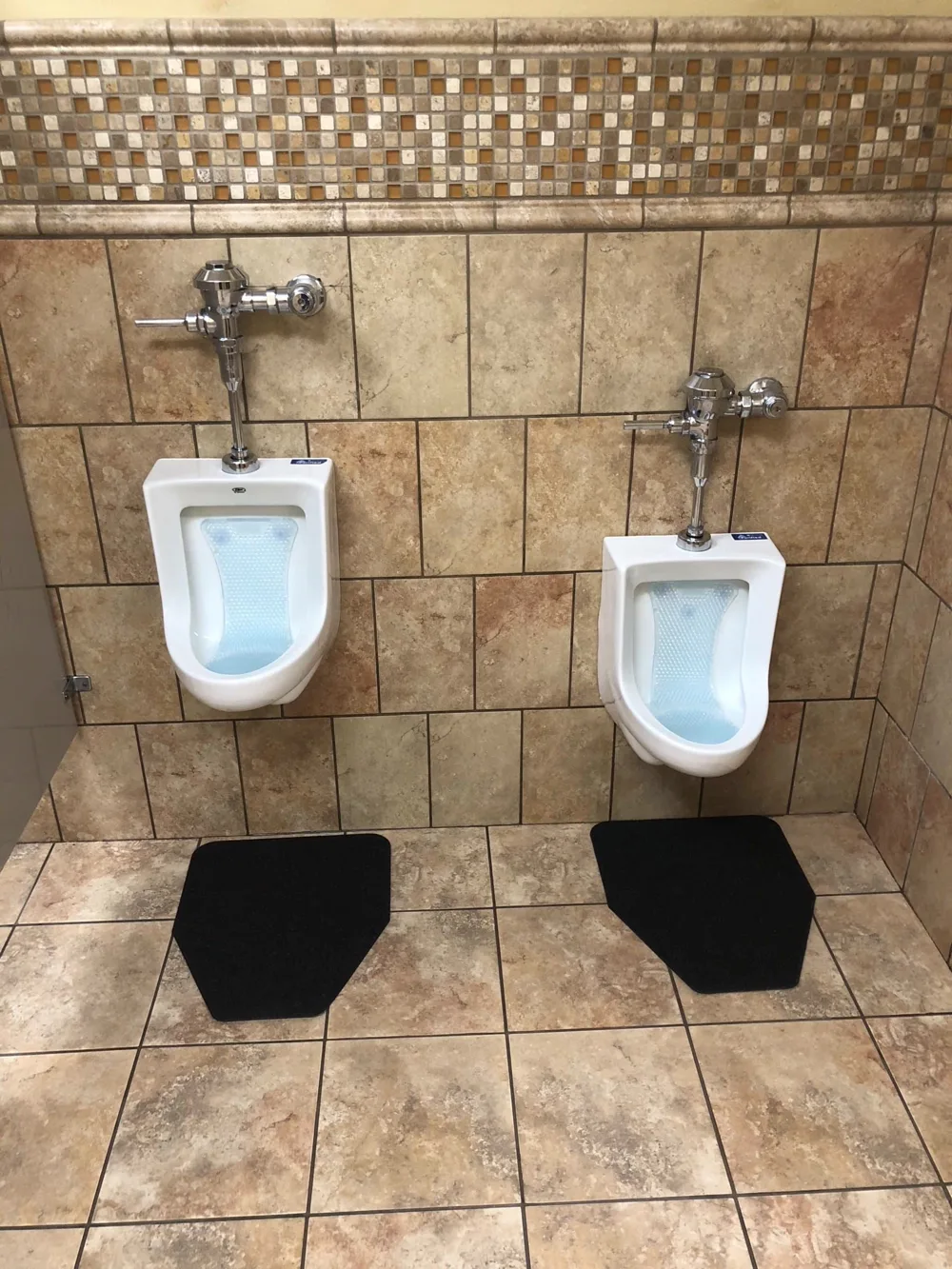 Sanitized urinals with Purified-branded dispenser